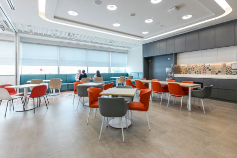 Q2 Solutions staff breakout and dining room in Singapore. The multi-function community space is designed for staff dining. The space is equipped for town hall meetings and staff training.