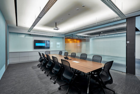 Acromec Ltd Offices. The main conference room incorporates industrial elements such as the expanded mesh, PET acoustic panelling and the suspended cable tray which carries the low cost uplighting for the room.