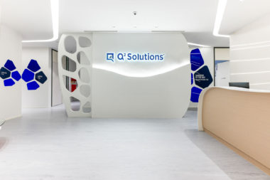 Q2 Solutions visitor reception for the offices and laboratories in Singapore. The interior design uses a thematic device to link areas and provide unity. 'Pursuits' creates flowing lines and white spaces. The sub-theme 'discovery' gives rise to the introduction of bold colours in key client facing areas.